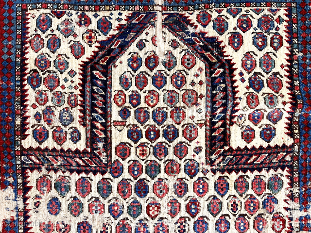 Early small Caucasian prayer rug. Very rough condition with obvious tears, creases and edge damage. Still has great presence. First rate color. Early 19th c. 3’3” x 3’10”     