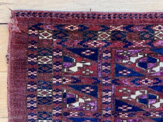 Lovely little Tekke aina gul mafash. Good tight medium pile with magenta silk highlights. Remnant end flat weave sewn down. Reasonably clean. 19th c.  
13” x 27”     