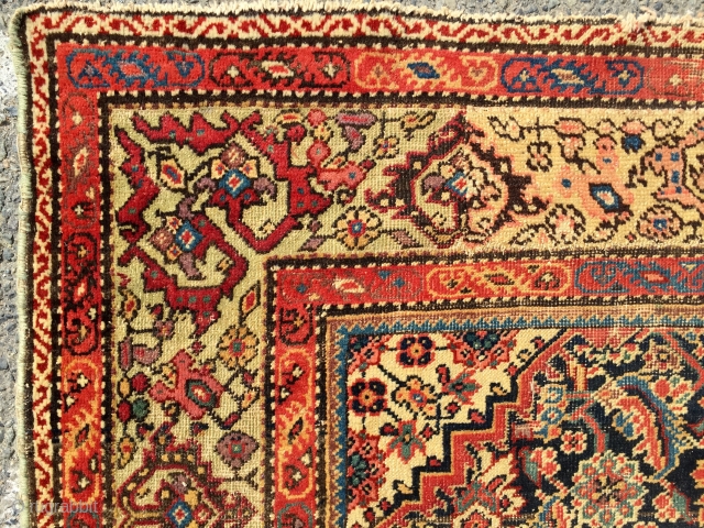 What remains of a genuine antique Persian ferrahan rug. Thin with overall very low pile. Tears, holes and scattered old repairs as shown. Pretty apple green border. Not restorable, good for patches  ...