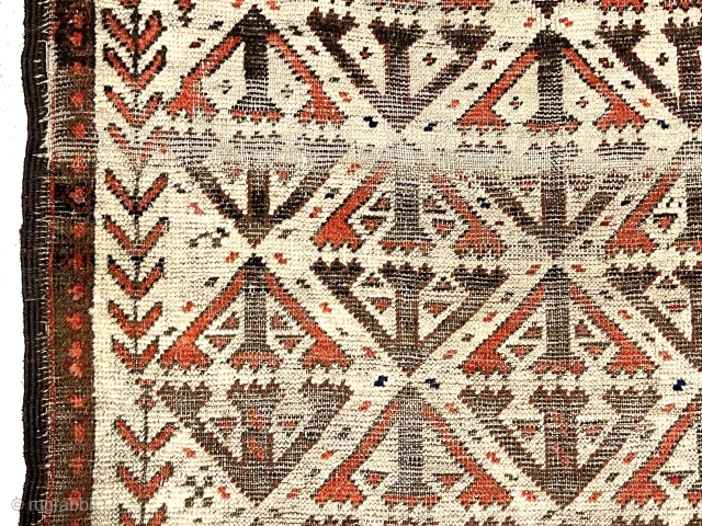 Antique small Baluch rug. Uncommon older ivory ground example. Interesting archaic field design I have not seen before as well as a dramatic design shift surprisingly at the top end. Unusual all  ...