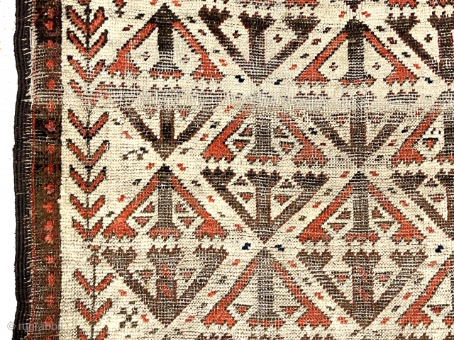 Antique small Baluch rug. Uncommon older ivory ground example. Interesting archaic field design I have not seen before as well as a dramatic design shift surprisingly at the top end. Unusual all  ...