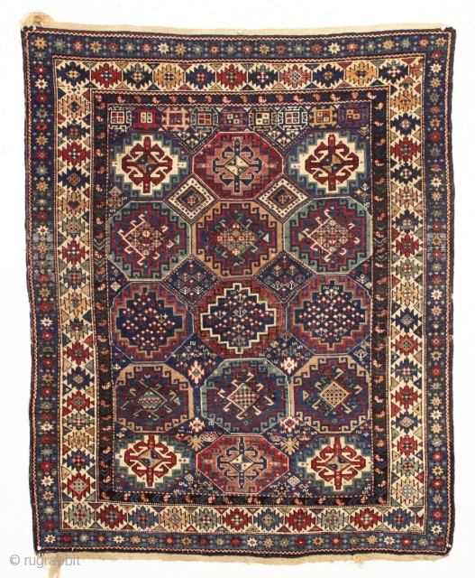antique kuba rug with an unusually large variety of designs in the field. The overall effect is of great delicacy and i don't think one could fit in much more. Overall pretty  ...