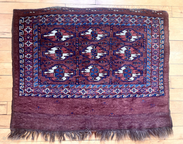 Antique Yomud chuval. Remarkably good condition for the age.Thick pile. All good natural colors. Fun little tent forms scattered in the skirt panel. The panel itself is interesting with two distinct dye  ...