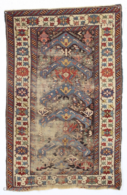 antique little east caucasian rug, probably best described as seichour, with an unusual variation of the bijov design. The light blue wing like medallions are hard to ignore. "as found", very dirty  ...