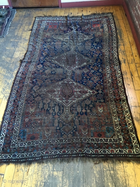 Back room storage clean out. Old South Persian rug. Dirty, worn, damaged. Priced accordingly. App 4'6" x 8'               