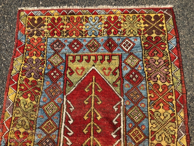 Antique Turkish village prayer rug. Simple, dramatic drawing. Good saturated natural colors including a rich tomato red, strong yellow, sky blues, lovely greens and a nice old aubergine. Overall low pile with  ...