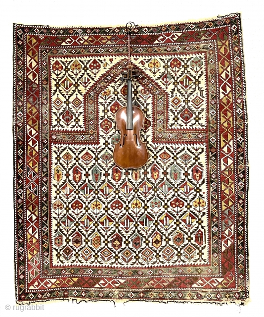 Unusually large antique Caucasian prayer rug. And yes that’s a violin pictured for scale. Overall excellent condition with even low pile and oxidized blacks. Slight end unraveling. Good saturated colors. No repairs.  ...