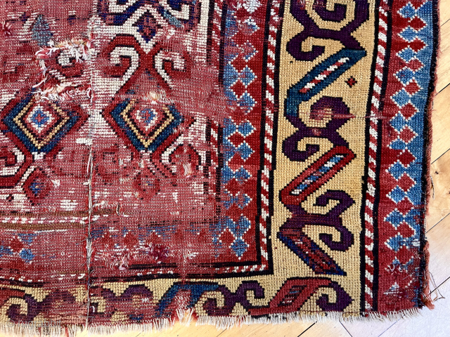 Early Kazak rug. Unusual and archaic drawing. Beautiful color including rich yellows and real purple. Battered and distressed. Heavy wear, tears and holes.  Priced accordingly. Interesting study piece. To me it’s  ...