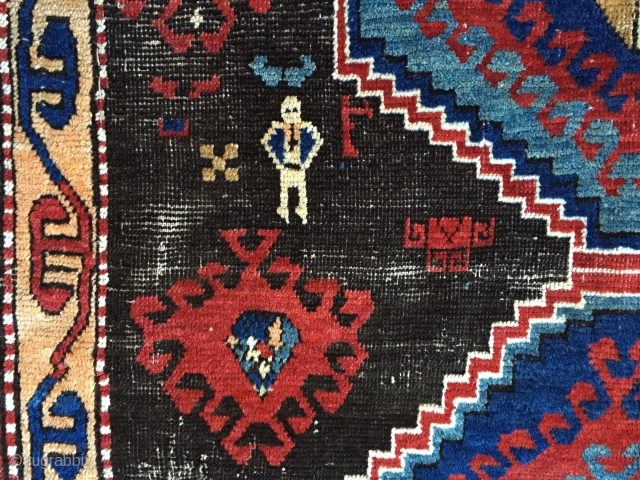 Business mans special. Antique Caucasian rug of some kind featuring a man wearing a tie. Kazak? Karrabaugh? Zakatala? Bold and compelling design with an unusual palette. Vibrant blues and reds along with  ...