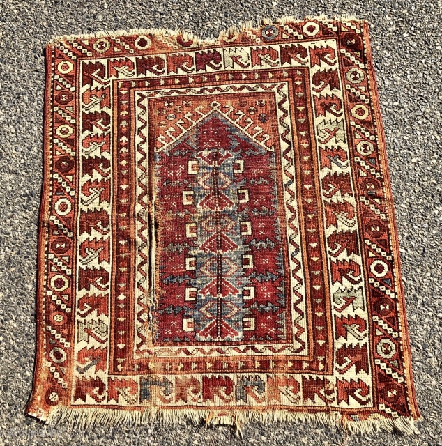 Antique little west Anatolian prayer rug. Interesting little rug found locally. I like the archaic serrated leaf border. Bergama? Coarse weave and overall low pile with  scattered wear and a good  ...