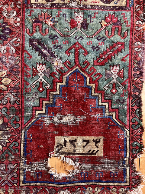 Early Anatolian prayer rug fragment with an unusual inscribed panel. Dated? Great color. Condition as shown. Needs mounting. Great project.  
Early 19th c. 2’7” x 5’ 6”     