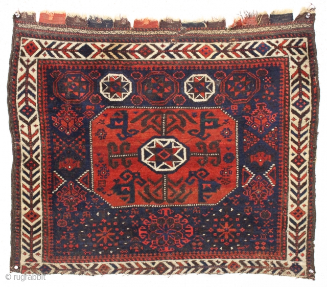 The second of a pair of antique baluch so called "octagon" bagfaces with an unusual design feature i have not seen before. The field motifs surrounding the center medallion change from top  ...