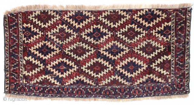 antique nascent or fragmentary turkoman asmalyk with an unusual border. Appears to have all natural dyes and an interesting and unusual palette. Various old small crude repairs and of course the big  ...