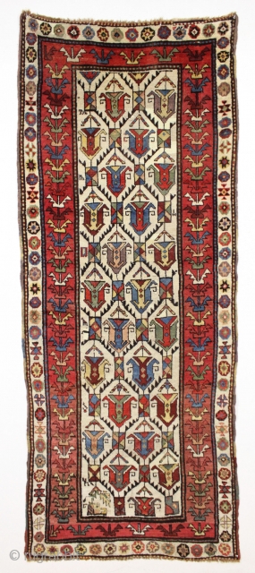 large antique ivory ground tribal persian rug with a great large scale palmette design. Rainbow colored main border. Possibly Luri? Beautiful natural colors including a fine old purple. Overall good condition with  ...