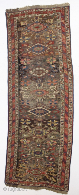 Antique caucasian kuba soumak long rug. Great yellows and greens. Original sides and end finish. The heavily oxidized brown ground has areas poorly filled in and should be restored. The design elements  ...