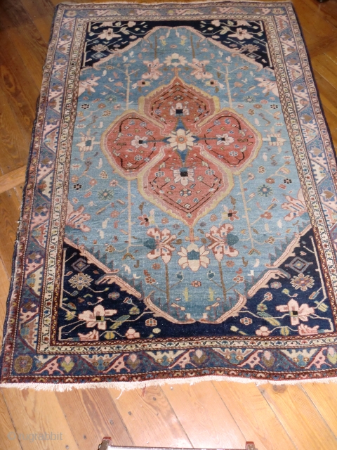 Serapi, blue field, medium sized ( 190x128 cm ). Over 100 yrs old ( survived the 2nd WW in a Berlin household) this rug shows signs of wear: selvages partly folded, many  ...