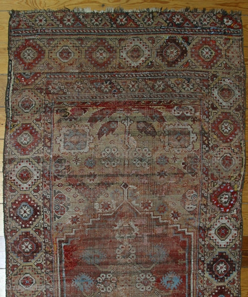 18th century Konya rug,W/W,225x110 cm.
Numerous repilings, inserts, loss of the small lateral outer borders. A unique central axis design that devides the entire field and incorporates the medaillon.     