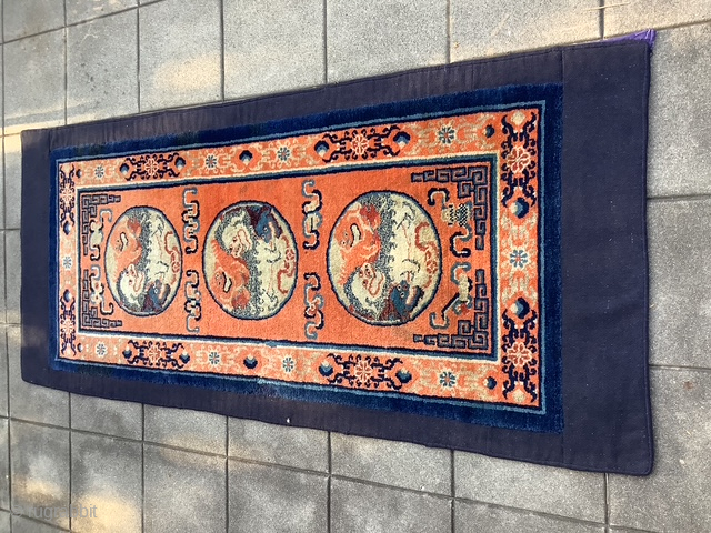 Chinese/Gansu rug woven for use by Tibetans probably as a Khaden. Typical dyed blue cotton back with added border of wool material not felt. Size 5’11” x 2’8”. Questions? Contact grtex131@gmail.com