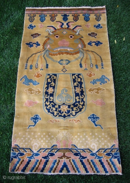 Chinese hanging/banner rug (3' 11" x 7' 4"); unusual t'ao-t'ieh mask design on pale gold field, full pile lustrous wool and in excellent condition; 20th century       