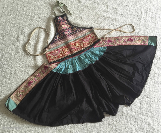 Child's Apron Tunic - Ethnic minority China. The wide flair of the skirt segment (119cm), created by dozens of tiny close pleats, is similar to the flower skirt of the Miao people.  ...