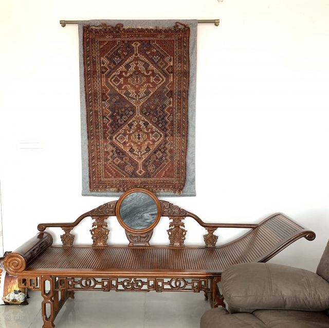 A gorgeous Qashqai with a backing. Worn out but still looks great on the wall. See more here: https://wovensouls.com/collections/antique-persian-rug-carpet/products/1074-antique-qashqai-rug-as-wall-art              