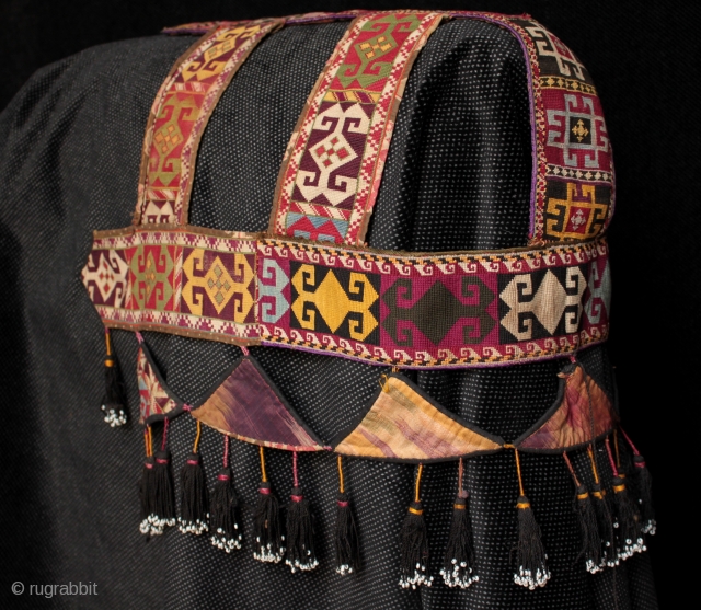 Rare Uzbek Lakai tribe camel headdress.

This camel headdress is formed from three different silk needlepoint embroidered bands, each with different borders, the main lower band with meander borders. Judging rom the motifs  ...