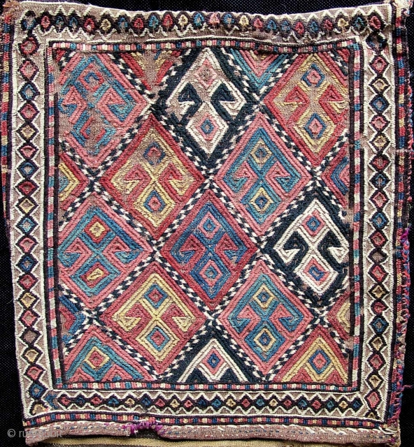 A complete rare early large Jaf style Kurdish zili heybe saddle bag. Unusual primitive abbreviated hands on hips type motifs, wool on wool flatweave foundation with a black goat hair warp. Hand  ...