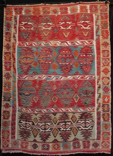 Rare and interesting late 19th century or early 1900s Cumra kilim with expressive drawing of intriguing motifs in the field which are perhaps variants of double winged elibelinde. From the village of  ...