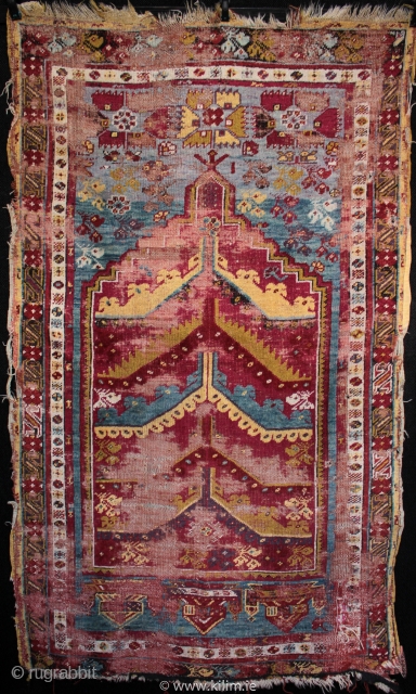  SOLD 19th century prayer rug from from Mucur in Kırşehir province, Central Anatolia.

An unusual mihrab with multiple arches, very good drawing and beautiful colours. Complete but worn with foundation showing, holes  ...