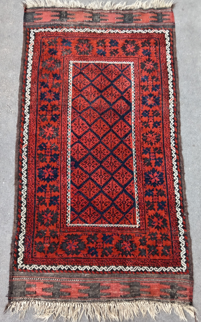 Old and colorful Baluch rug (176 cm. x 96 cm.) Very good condition for its age, complete, with corroded black, intense solid orange and deep blue ground. Only few very small moths  ...