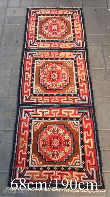 Tibetan rug, re color and three joined with single group flower pattern. Wool warp and weft. Late Qing Dynasty. Good and condition. Size 68*190cm(27*74”)         