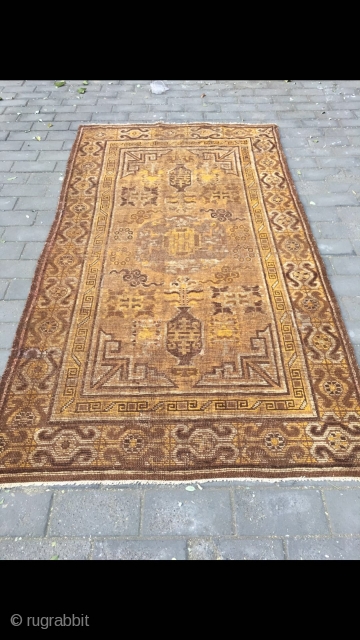 #2023 Xinjiang carpet. It was produced in Khotan area. Late 19th / circa 1900. Brown background with Xinjiang Khotan flowers pattern, some early synthetic color . Wool weft and cotton warp. Size  ...