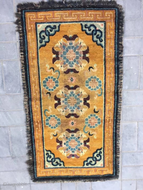 Tibet rug, yellow background with nice group flowers pattern, Lucky clouds  in the four corner. Good age and condition. Size 160*88cm(62*34”). Wool warp and weft       