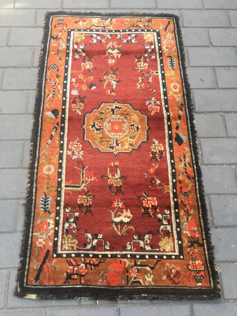 #1903 Tibet rug, red background wiht single group flower and around full of flower pattern.
good age and quality. wool warp and weft. size 165*88cm( 65*34'')        