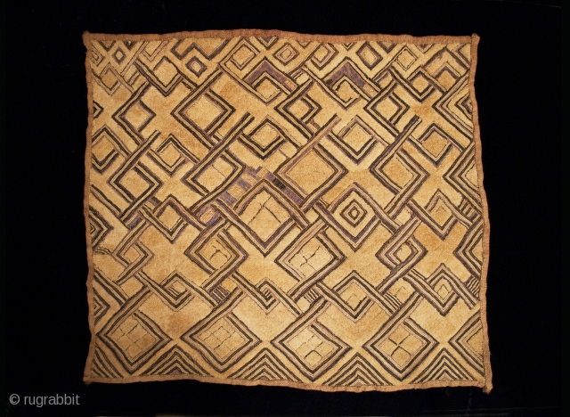 Cut-pile raffia panel.
Shoowa, a northern group of the Kuba, D.R. Congo.
27" (69 cm) by 24" (61 cm) approx.
Mid-20th century.
In pieces from this time period, the purple color is said to be produced  ...