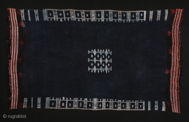 Mahmoudi (woman's mantle). Wool with cotton supplementary patterns, tie-dyed at edges. The piece is dyed after weaving and the cotton resists the indigo. 47" by 83" (119 by 210 cm). Berber people,  ...