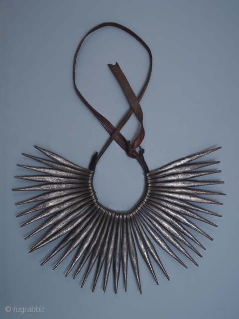 Pikuran, cache-sexe,
Kirdi peoples, Mandara Mountains, Cameroon.
Iron, leather
The row of spikes is 6.5" (16.5 cm) wide by 4.75" (12 cm) high
Early to mid-20th century
Worn by young women, the spikes on this cache-sexe curve  ...