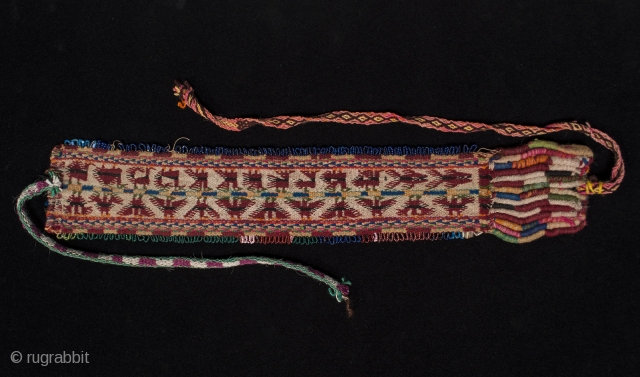 Headband, Bolivia. 16" by 3". Wool, beads. Mid 20th century. Condors, fish and various four-legged beasts are woven into this headband, which is bordered by loops of colorful beads. In good condition,  ...