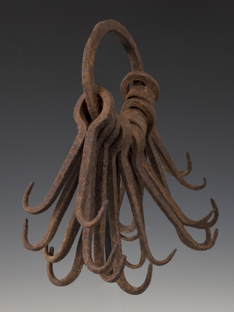 Ring of double hooks,
possibly West Africa.
Hand forged iron,
8" (20.2 cm) high,
Early to mid 20th century.

This might be an unusual type of currency or utilitarian object.        