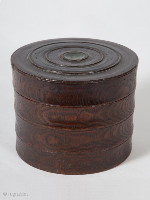 Small box,
Korea.
Zelkova (elm) wood, green paint,
4.25" 10.8 cm) high, 5.5" (14 cm) diameter.
Late 19th to early 20th century.
This unique, beautifully grained box has been carved as if there were three separate tiers  ...