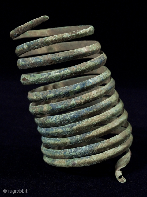 Large coiled bracelet,
Near East.
Bronze.
4.75" (12 cm) high, 8.25" (21 cm) upper circumference
Late 2nd to early 1st century B.C.
Formed from a continuous band with rounded outer surface and flat interior.    