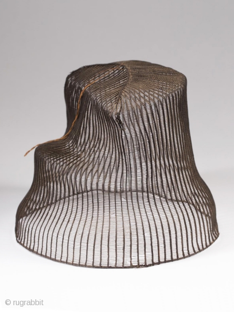 Tanggeon with base,
Korea.
Horsehair, wood,
21" (53.3 cm) in circumference, 6" (15.2 cm) high.
Late 19th to early 20th century.
The tanggeon was worn by nobility, as well as men in the commercial and medical fields.  ...