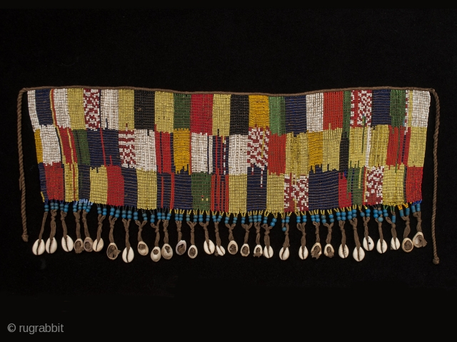 Pikuran (cache-sex),
Bana Guili people, Mandara Mountains, Cameroon.
Seed beads, cotton string, cowrie shells,
21" (53.3 cm) wide by 9" (22.8 cm) high
Mid 20th century.
These colorful cache-sex were worn for celebrations, rituals and rites of  ...