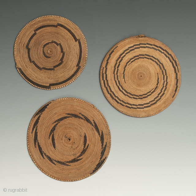 These woven grass presentation plates, "agakoko", were offered as gifts at special occasions. Tutsi people, Rwanda. They measure 4.5" (11.3 cm) to 5" (12.2 cm) and are in beautiful condition. Early to  ...