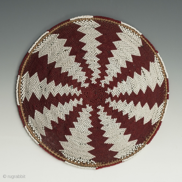 Zulu beer pot cover "Imbenge" made with woven grass covered with very small seed beads. it measures 1.5"(3.3 cm) high x 8" (20.3 cm) diameter. South Africa. Mid-20th century. Ex. David Roberts.  ...