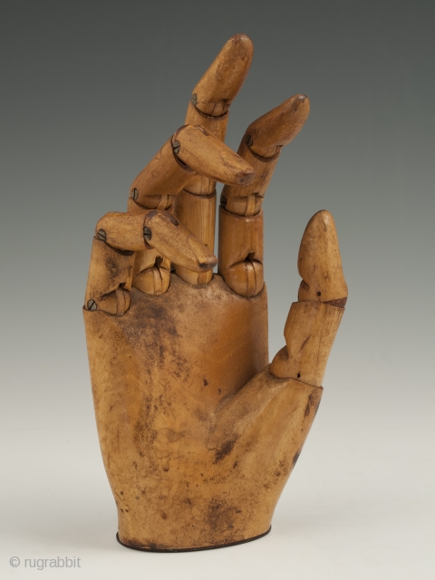 An expressive articulated carved wood mannequin hand, likely made in France. It measures 7" (17.7 cm) high by 3" (7.6 cm) wide. Late 19th to early 20th century.

     