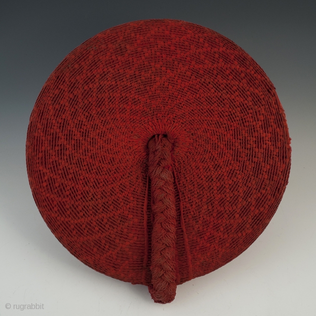 Woman's hat, Isicholo, Zulu people, South Africa. Cotton, wire, 11" (28 cm) in diameter by 3" (7.6 cm) high, Mid 20th century.
The unusual spiral weave on this cotton Isicholo makes this a  ...