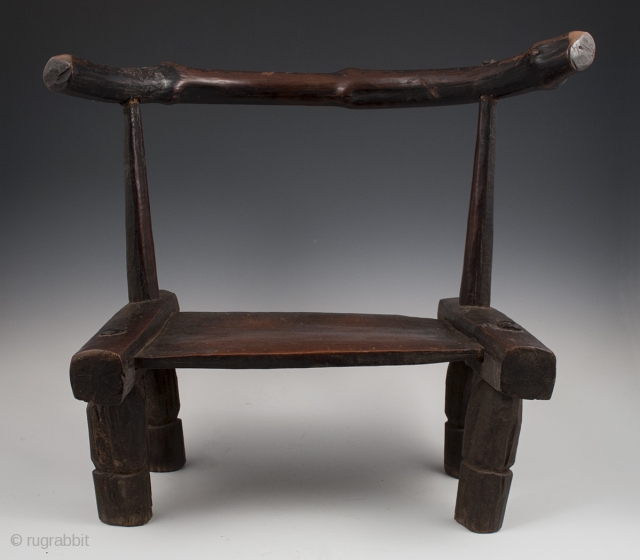 Small chair,
Dan tribe, West Africa.
15" (38 cm) high by 17.75" (45 cm) wide by 12" (30.5 cm) deep.
Mid 20th century.             