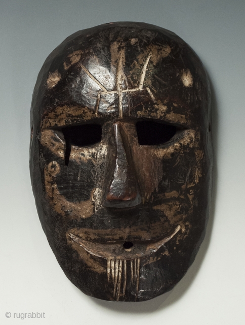 Mask, Middle Hills, Nepal. Wood, 9″ (22.8 cm) high by 6″ (15.2 cm). Early 20th century. A Middle Hills mask with several unusual markings: a trisula carved into the forehead, white painted  ...