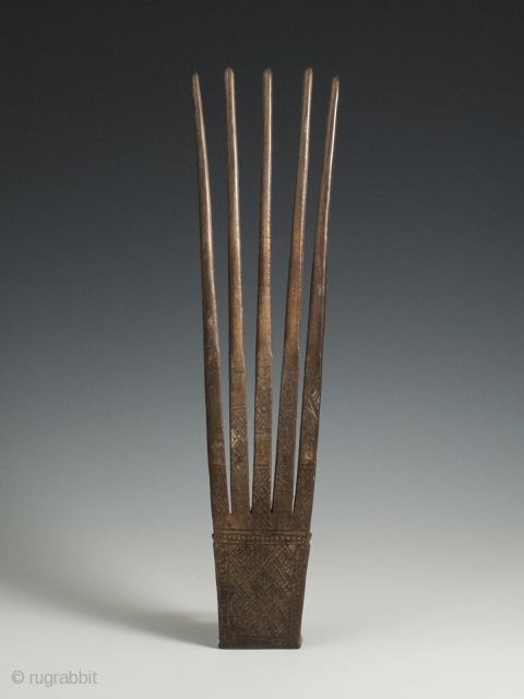 Horn Comb, Timor Island, 11.75" (30 cm) high by 3" (7.5 cm) wide, early 20th century. This five-pronged carved horn comb is notable for its large size and has a smooth patina  ...